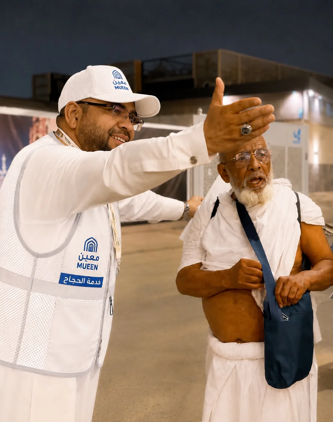 A Moeen team member guiding an elderly pilgrim