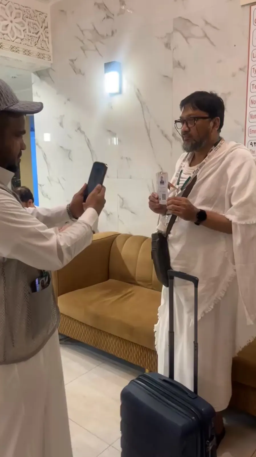 Moeen employee using a mobile device during hotel service